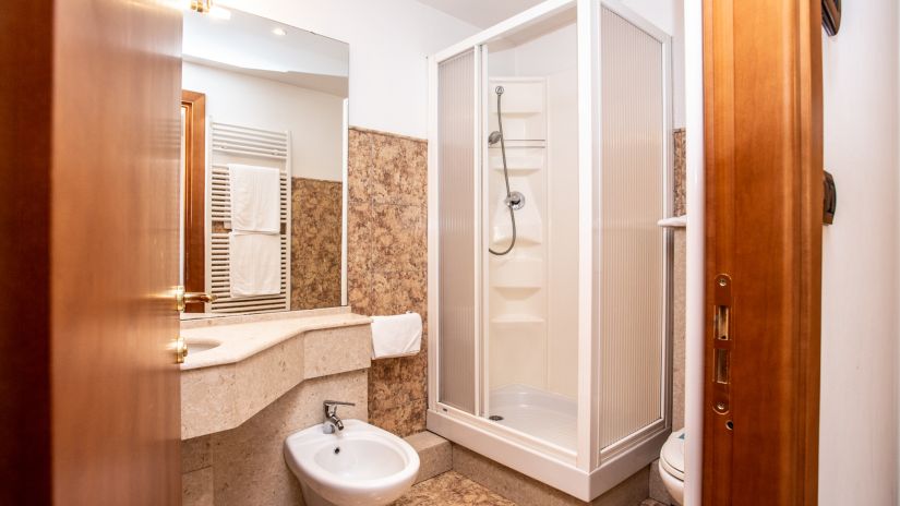 Salle de bains avec cabine de douche, bidet et lavabo